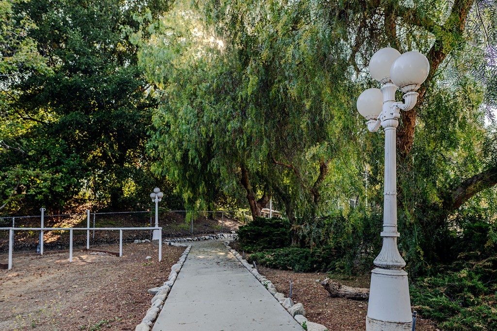 Tree-lined walking path and lampposts on the Serenity Ranch grounds