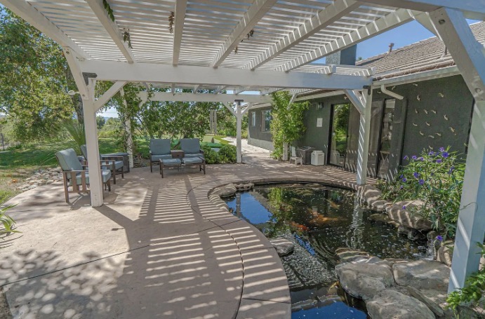 Pergola patio with koi pond at Serenity Ranch